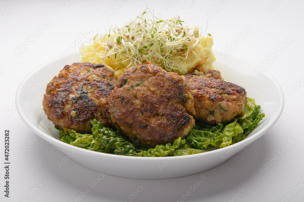 studio shot of meatballs with mashed potatoes and bean sprouts as decoration against a white background studio shot of meatballs with mashed potatoes and bean sprouts as decoration against a white background