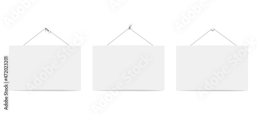 Three blank white boards for messages or photo hanging on ropes.