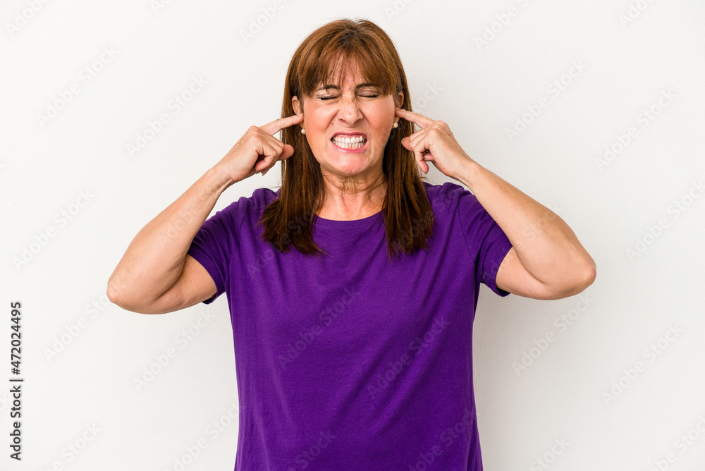 Middle age caucasian woman isolated on white background covering ears with fingers, stressed and desperate by a loudly ambient. Middle age caucasian woman isolated on white background covering ears with fingers, stressed and desperate by a loudly ambient.