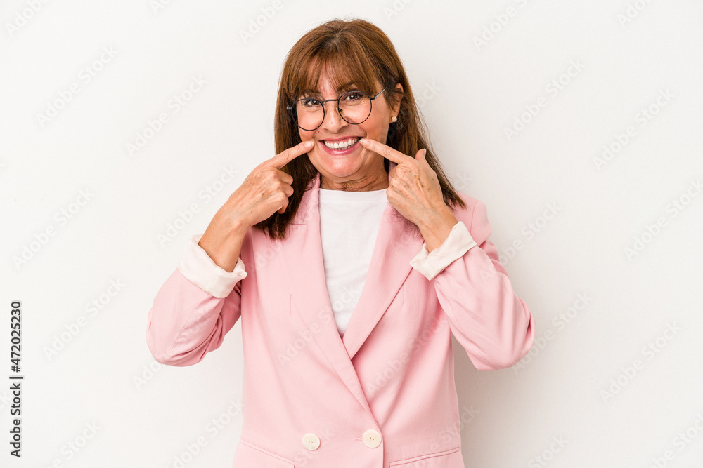 Middle age caucasian woman isolated on white background smiles, pointing fingers at mouth. Middle age caucasian woman isolated on white background smiles, pointing fingers at mouth.