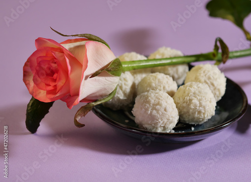 pink rose and Raffaello sweets on a plate