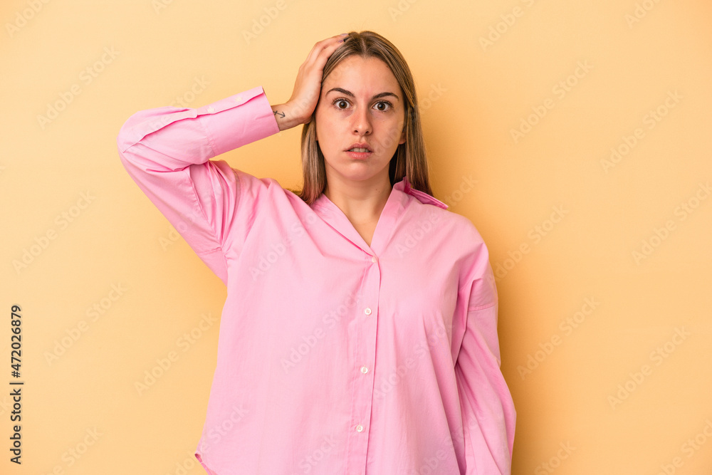 Young caucasian woman isolated on yellow background being shocked, she has remembered important meeting. Young caucasian woman isolated on yellow background being shocked, she has remembered important meeting.