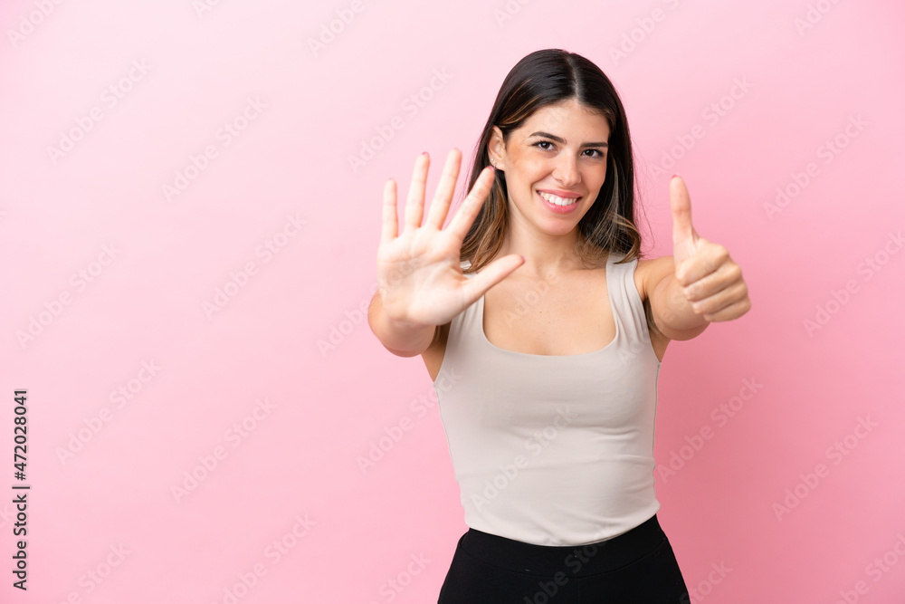 Young Italian woman isolated on pink background counting six with fingers Young Italian woman isolated on pink background counting six with fingers
