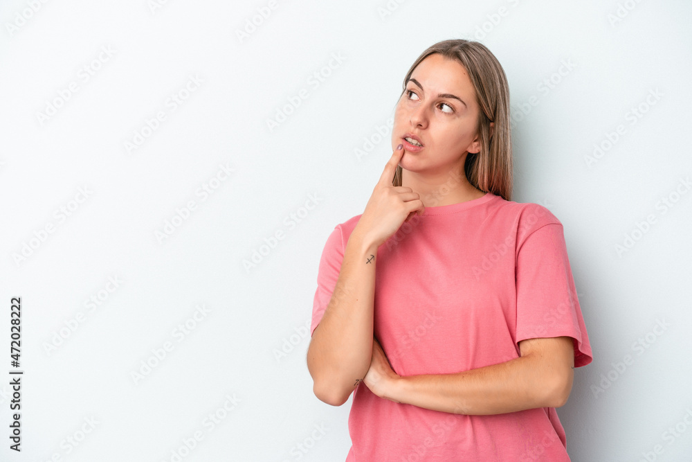 Young caucasian woman isolated on blue background looking sideways with doubtful and skeptical expression. Young caucasian woman isolated on blue background looking sideways with doubtful and skeptical expression.