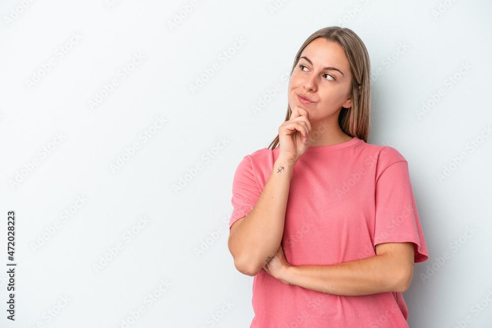 Young caucasian woman isolated on blue background looking sideways with doubtful and skeptical expression. Young caucasian woman isolated on blue background looking sideways with doubtful and skeptical expression.