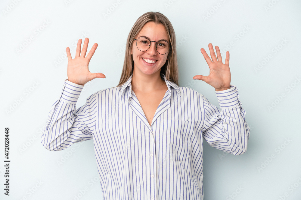 Young caucasian woman isolated on blue background showing number ten with hands. Young caucasian woman isolated on blue background showing number ten with hands.