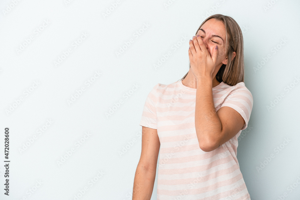 Young caucasian woman isolated on blue background laughing happy, carefree, natural emotion. Young caucasian woman isolated on blue background laughing happy, carefree, natural emotion.