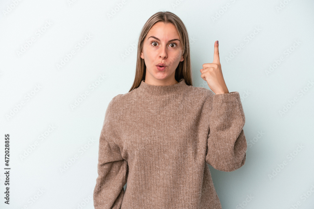 Young caucasian woman isolated on blue background having some great idea, concept of creativity.