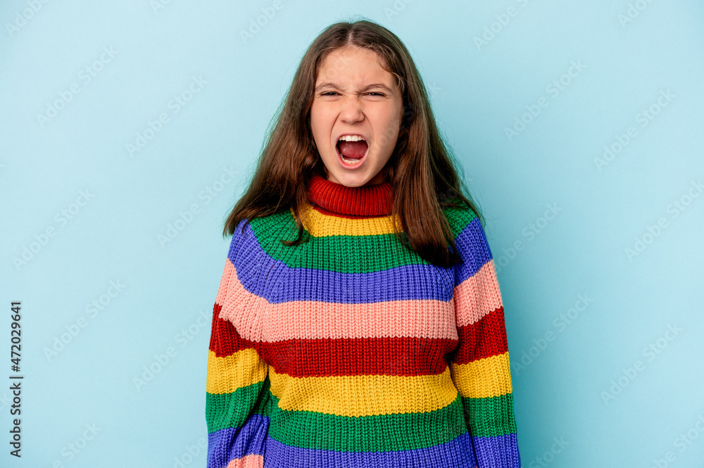 Little caucasian girl isolated on blue background screaming very angry and aggressive. Little caucasian girl isolated on blue background screaming very angry and aggressive.