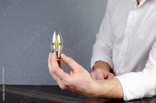 Wallpaper Mural Light bulb in hand. A man holds a light bulb in his hand. Idea. A bright thought. Torontodigital.ca