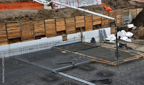Konstfotografi concreting the floor of underground garages with the help of a mixer and a pump with a hose