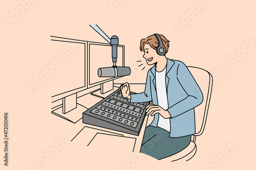 Smiling guy presenter in headphones talk in microphone on radio with listeners. Happy man host present online have communication with followers. Entertainment concept. Vector illustration. 