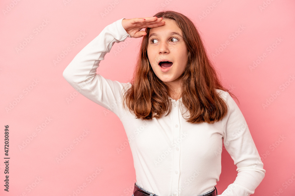 Little caucasian girl isolated on pink background looking far away keeping hand on forehead. Little caucasian girl isolated on pink background looking far away keeping hand on forehead.