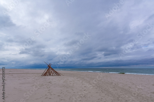 Seascape. Wooden hut on a sandy beach by the Baltic Sea on a windy autumn day