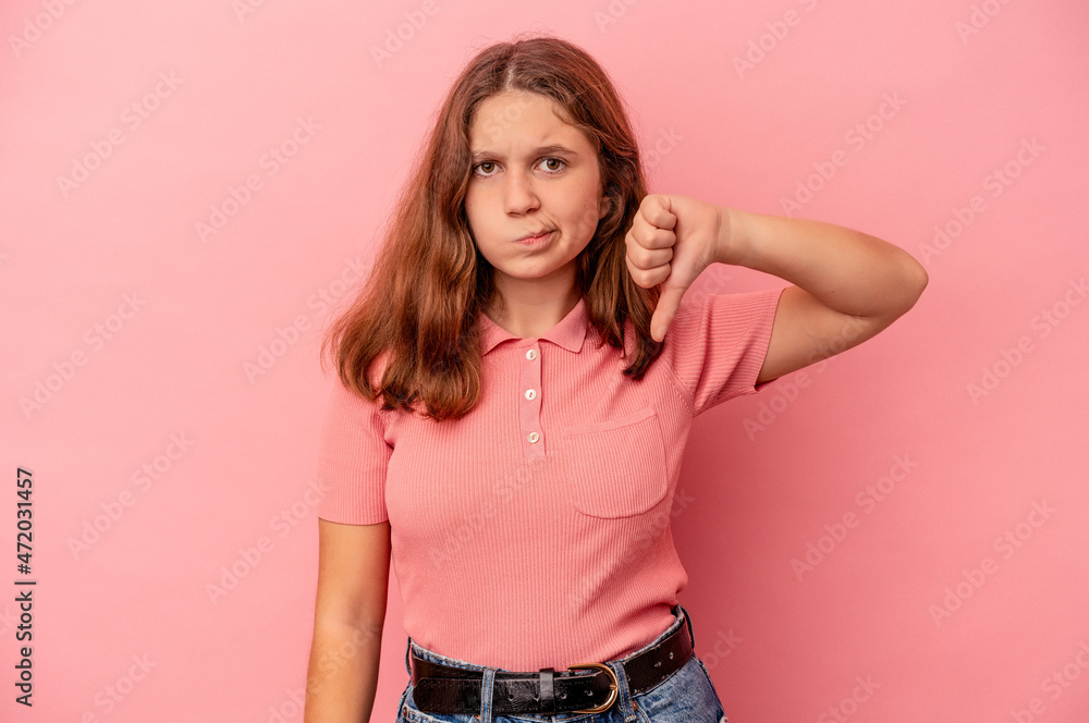 Little caucasian girl isolated on pink background showing thumb down and expressing dislike. Little caucasian girl isolated on pink background showing thumb down and expressing dislike.