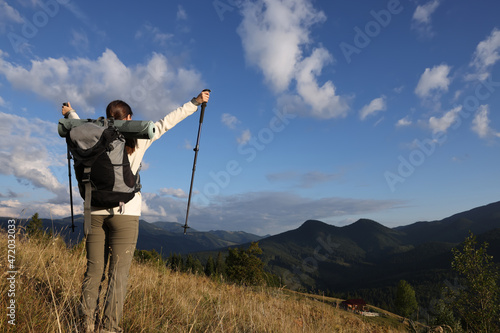 Triumphant tourist on top of mountain, back view. Space for text