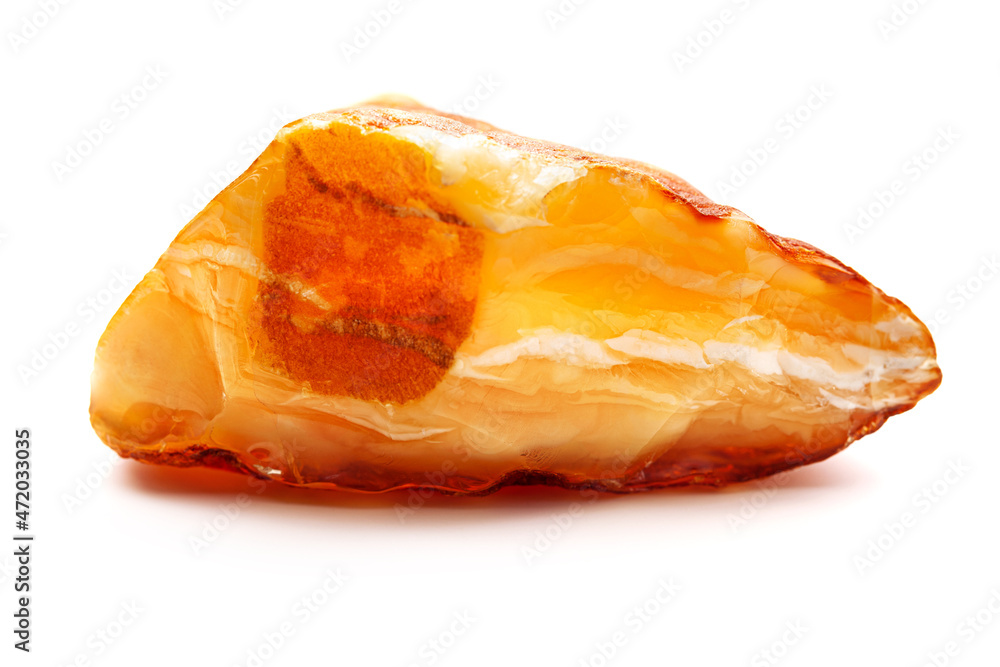 Natural amber. A piece of yellow opaque natural amber on white background. Natural amber. A piece of yellow opaque natural amber on white background.
