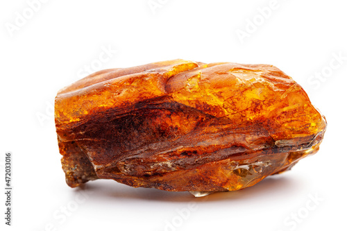 Natural amber. A piece of yellow opaque natural amber on white background.