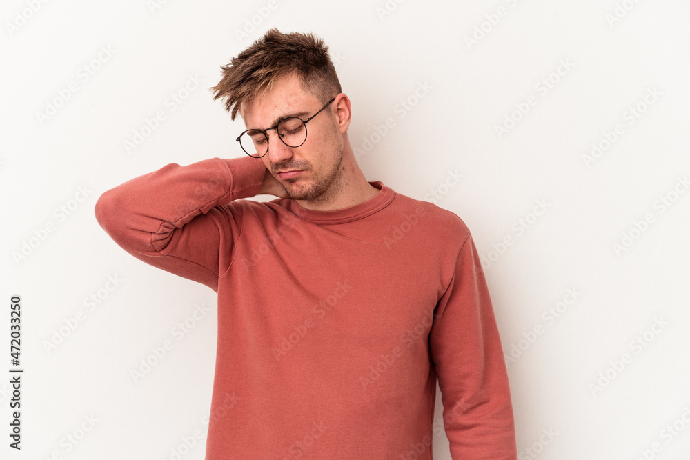 Young caucasian man isolated on white background having a neck pain due to stress, massaging and touching it with hand. Young caucasian man isolated on white background having a neck pain due to stress, massaging and touching it with hand.