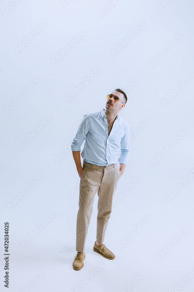 Portrait of young man, hipster or dandy, dude dressed in 50s, 60s style isolated on white background. retro vintage style
