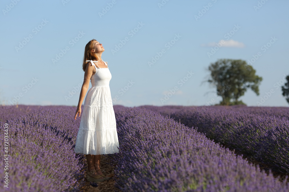 Full body of woman breathing in lavender field Full body of woman breathing in lavender field