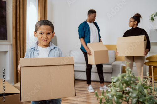 The family is getting ready to move out of apartment, the parents talk arrange the details of the moving, little boy helps carry out boxes, packs him things, renting house, buying a flat