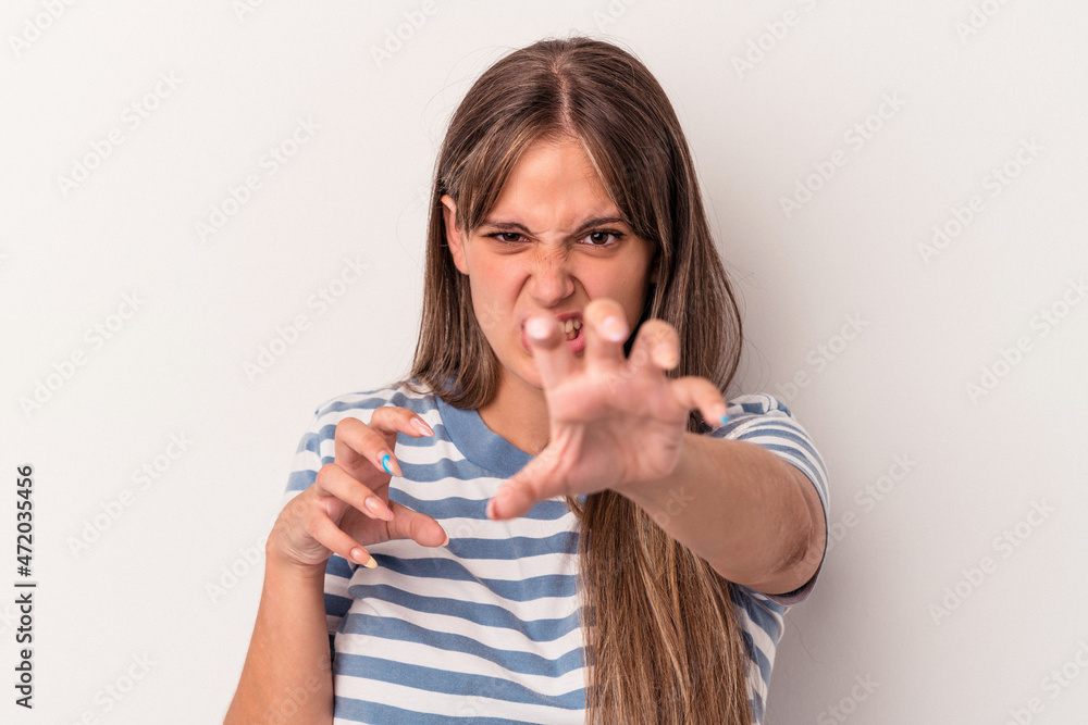 Young caucasian woman isolated on white background showing claws imitating a cat, aggressive gesture. Young caucasian woman isolated on white background showing claws imitating a cat, aggressive gesture.
