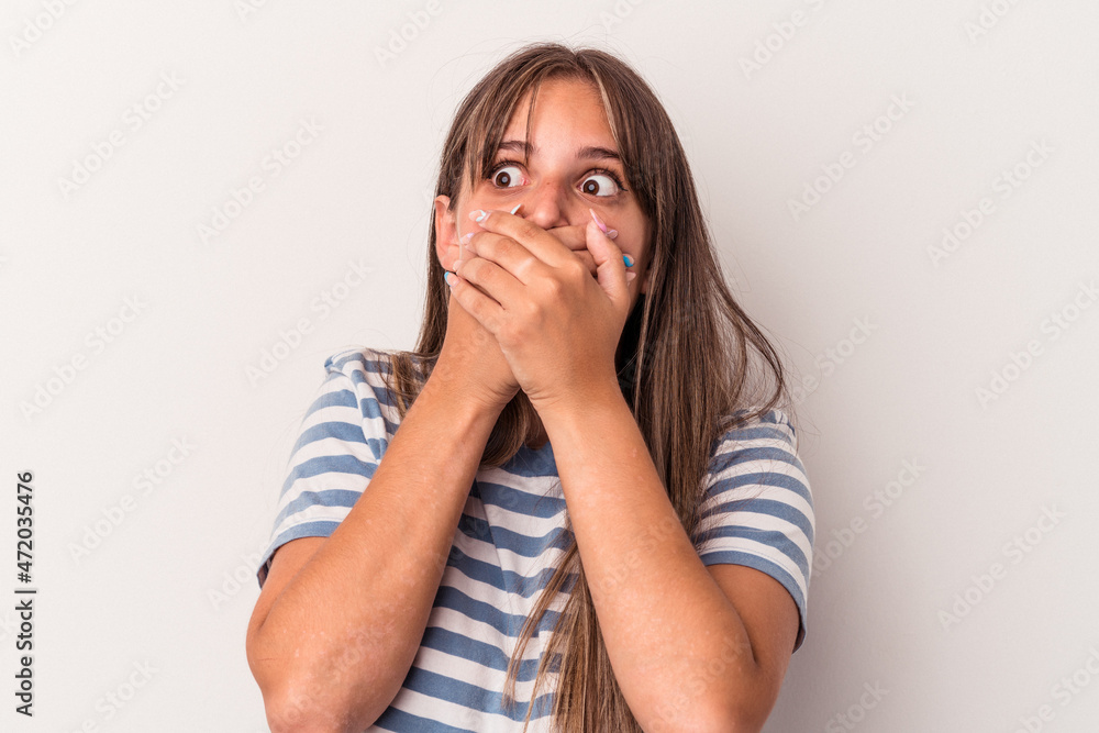 Young caucasian woman isolated on white background thoughtful looking to a copy space covering mouth with hand. Young caucasian woman isolated on white background thoughtful looking to a copy space covering mouth with hand.
