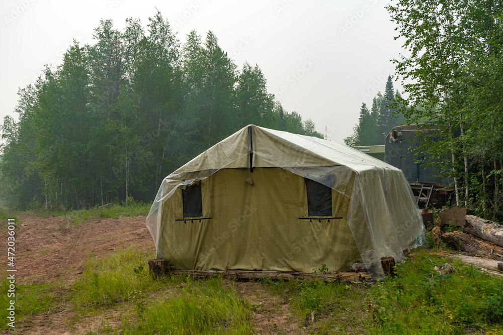 Military tent in the field. field camp in nature. large green tarpaulin tent. Army camp.