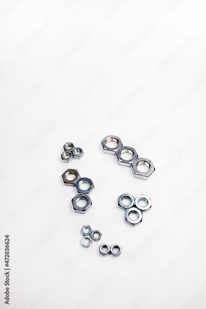 Many different screws on a white background. Equipment repair and construction Many different screws on a white background. Equipment repair and construction
