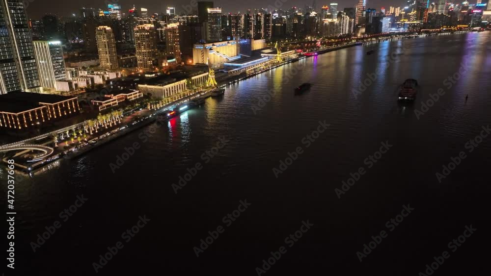 Drone aerial view of waterfront of Shanghai Huangpu River in night. Landmark river and cityscape skyline in China. Travel tourism transportation and business concept b-roll footage. The bund area Drone aerial view of waterfront of Shanghai Huangpu River in night. Landmark river and cityscape skyline in China. Travel tourism transportation and business concept b-roll footage. The bund area