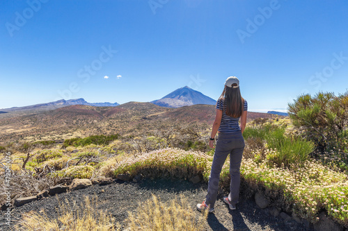 Young woman enjoying view on volcano Teide on Tenerife island, Spain