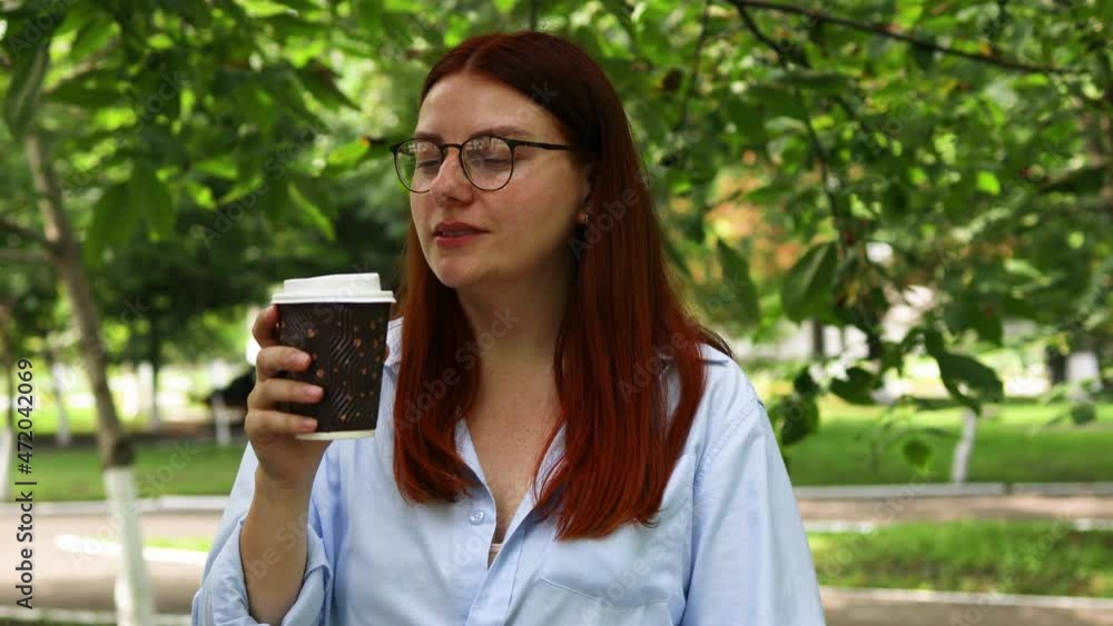 4k Beautiful woman drinking coffee, enjoying holding cup in hands outdoors on cloudy day 4k Beautiful woman drinking coffee, enjoying holding cup in hands outdoors on cloudy day