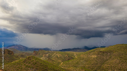 Aerial drone image of a monsoon over the Sonoran Desert of Arizona with rugged terrain.
