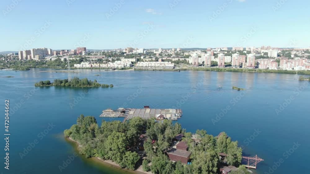 Trout Island. Fish are grown in stores. Small business trout farm in the City of Irkutsk. Shooting from a drone. view from above. Angara river. Trout Island. Fish are grown in stores. Small business trout farm in the City of Irkutsk. Shooting from a drone. view from above. Angara river.