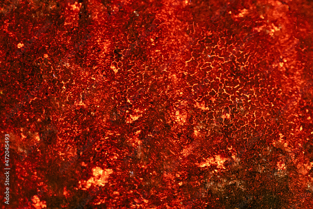 Red hot lava texture. Volcanic eruption. Space shiny backdrop.