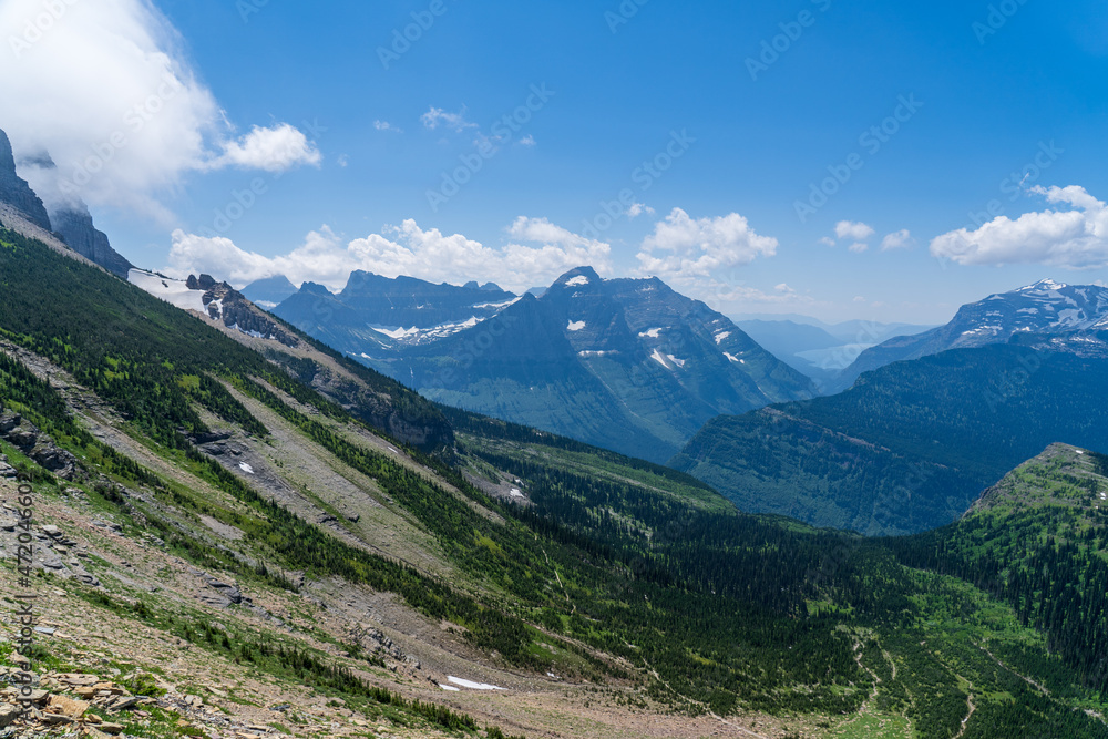 View of the Garden Wall, Grinnell Glacier Overlook, Lake McDonald, and the Continental Divide while hiking the Highline Trail in Glacier National Park in Montana on a sunny summer day
