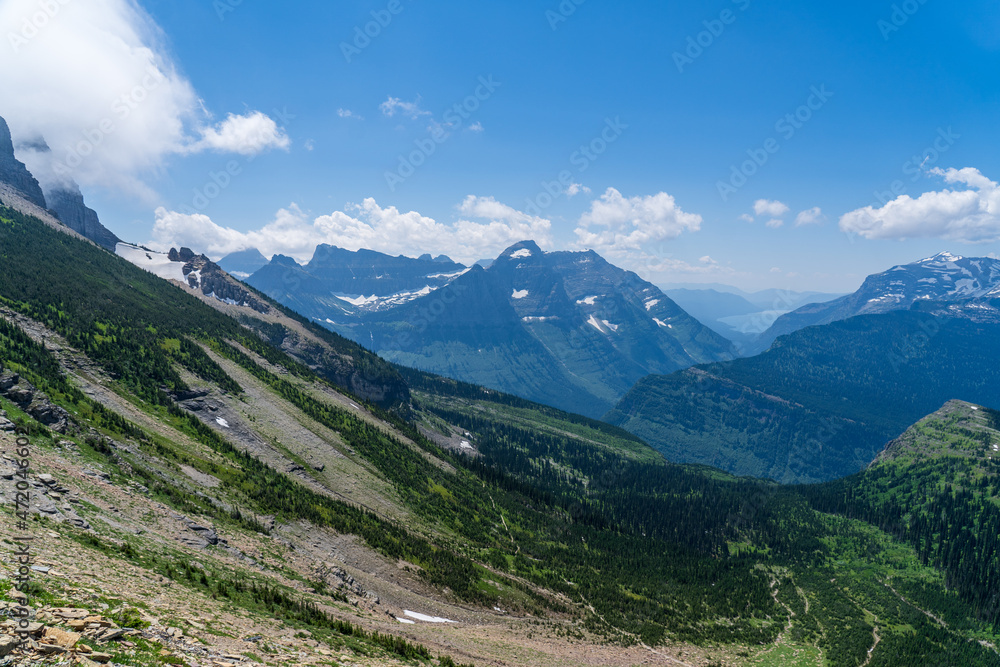 View of the Garden Wall, Grinnell Glacier Overlook, Lake McDonald, and the Continental Divide while hiking the Highline Trail in Glacier National Park in Montana on a sunny summer day View of the Garden Wall, Grinnell Glacier Overlook, Lake McDonald, and the Continental Divide while hiking the Highline Trail in Glacier National Park in Montana on a sunny summer day