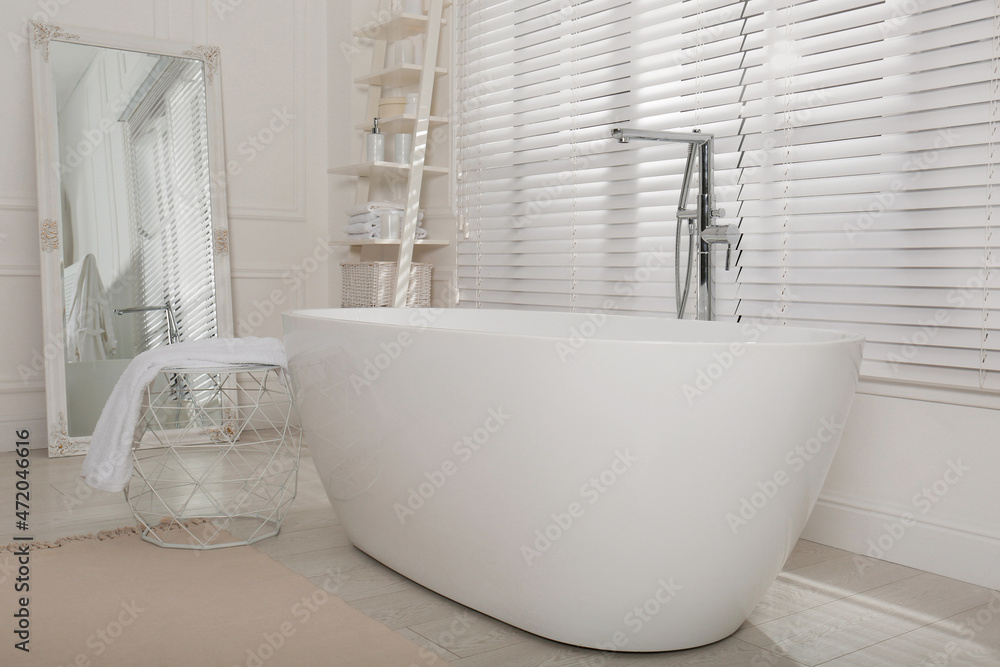 Minimal bathroom interior with modern white tub Minimal bathroom interior with modern white tub