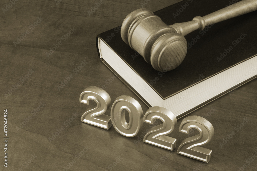 Wooden judge gavel, legal book and numbers 2022. New laws and rules in year 2022. Wooden judge gavel, legal book and numbers 2022. New laws and rules in year 2022.