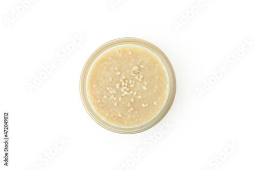 Tahini sauce in bowl isolated on white background