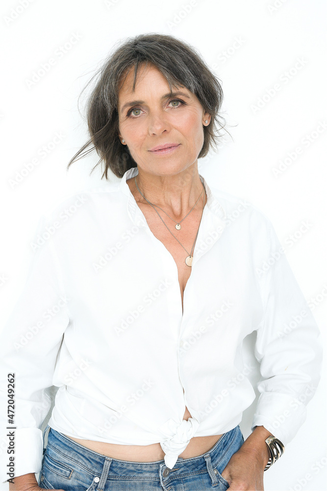 Beautiful woman in casual clothing standing against white background Beautiful woman in casual clothing standing against white background