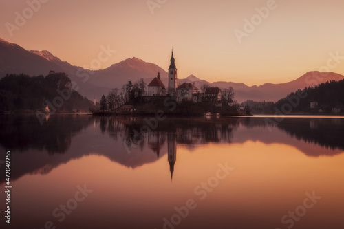 Picturesque sunrise on the lake Bled. Perfect reflection of the church in smooth water. Atmospheric mood. Nature background. The nature of Slovenia. Lake Bled.Parish Church of St. Martina. Europe