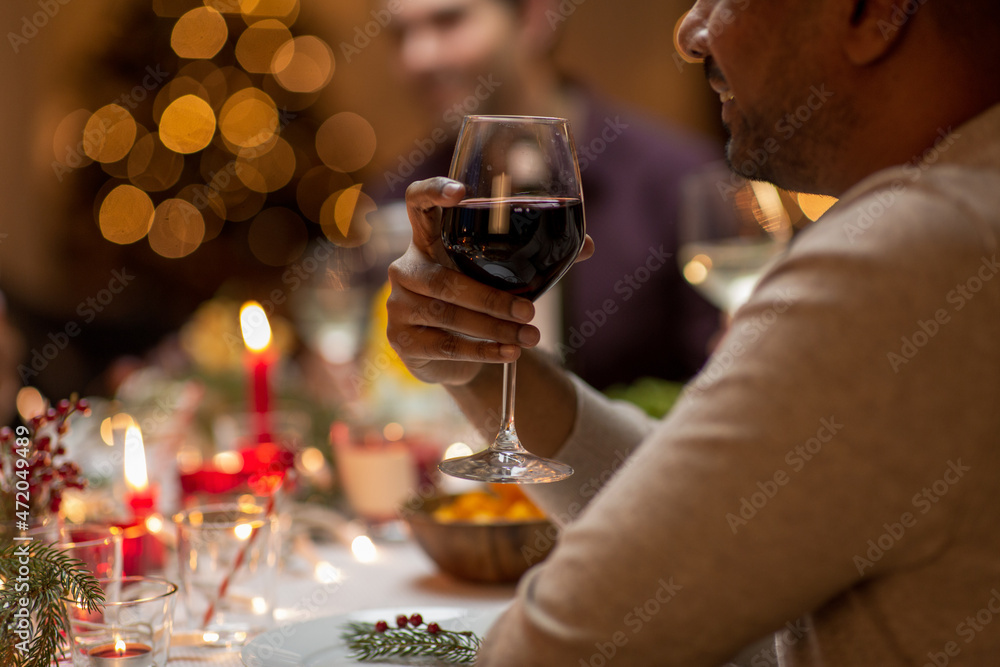 holidays, party and celebration concept - close up of happy smiling man having christmas dinner at home and drinking red wine holidays, party and celebration concept - close up of happy smiling man having christmas dinner at home and drinking red wine