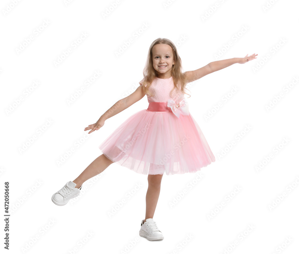 Naklejka premium Cute little girl in beautiful dress dancing on white background