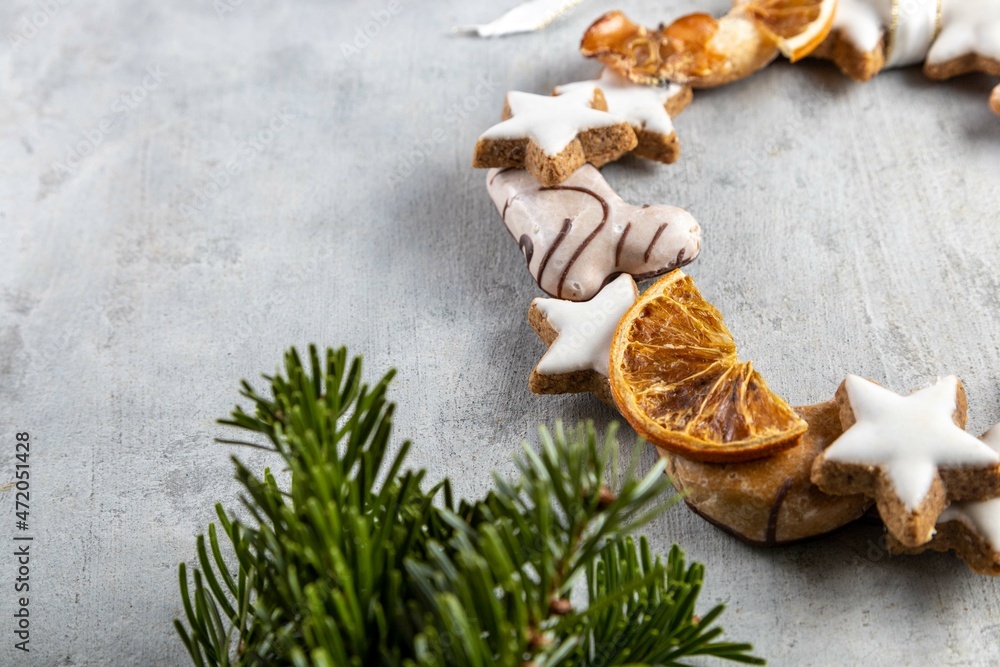 Christmas wreath of cookies and winter spices and christmas tree on a light background. Christmas wreath of cookies and winter spices and christmas tree on a light background.