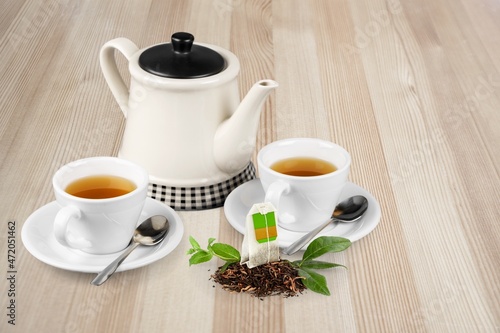 Cup of tea with fresh green leaf or flower