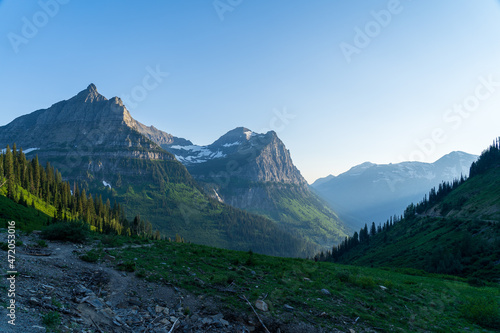View of Mount Oberlin and Clements Mountain in Glacier National Park as viewed from hiking by Oberline Bend on the Going to the Sun Road on a sunny summer evening at sunset and golden hour photo