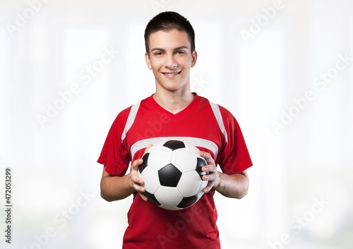Professional football soccer player standing with ball © BillionPhotos.com