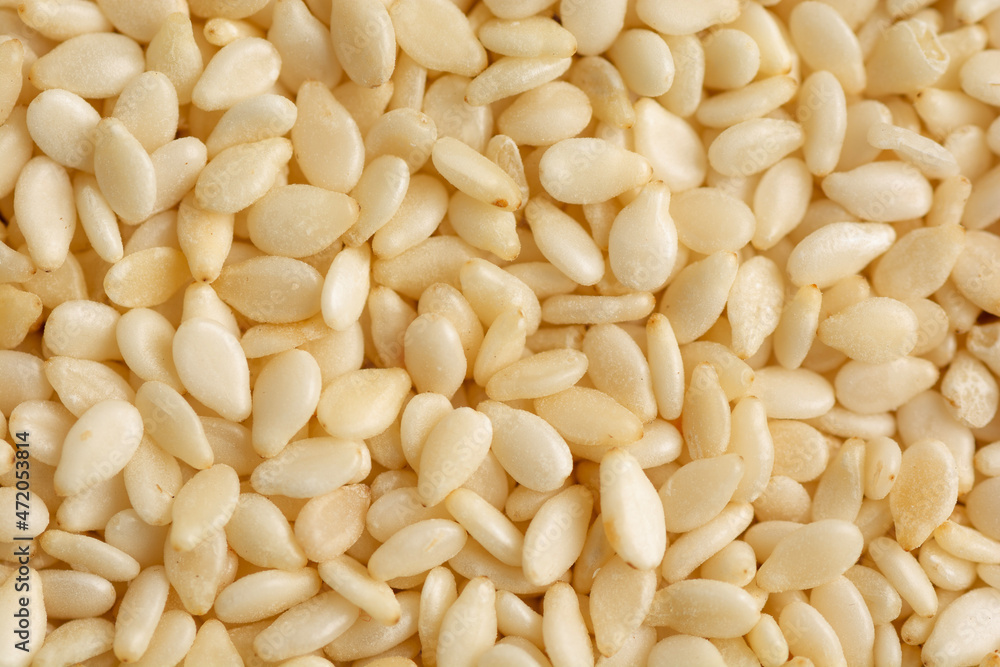 White sesame seeds background close up White sesame seeds background close up